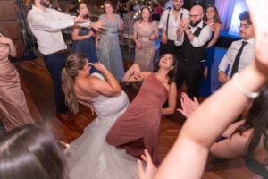 Bride and bridesmaid dancing at wedding